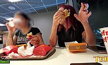 Two sexually aroused women have their breasts exposed while dining at McDonald's - featuring a professionally inked angel
