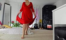 Sensual mature Sonia's home video showcasing her teasing poses in a lengthy red dress, revealing her hairy upskirt, legs, feet, and hips, with natural breasts.